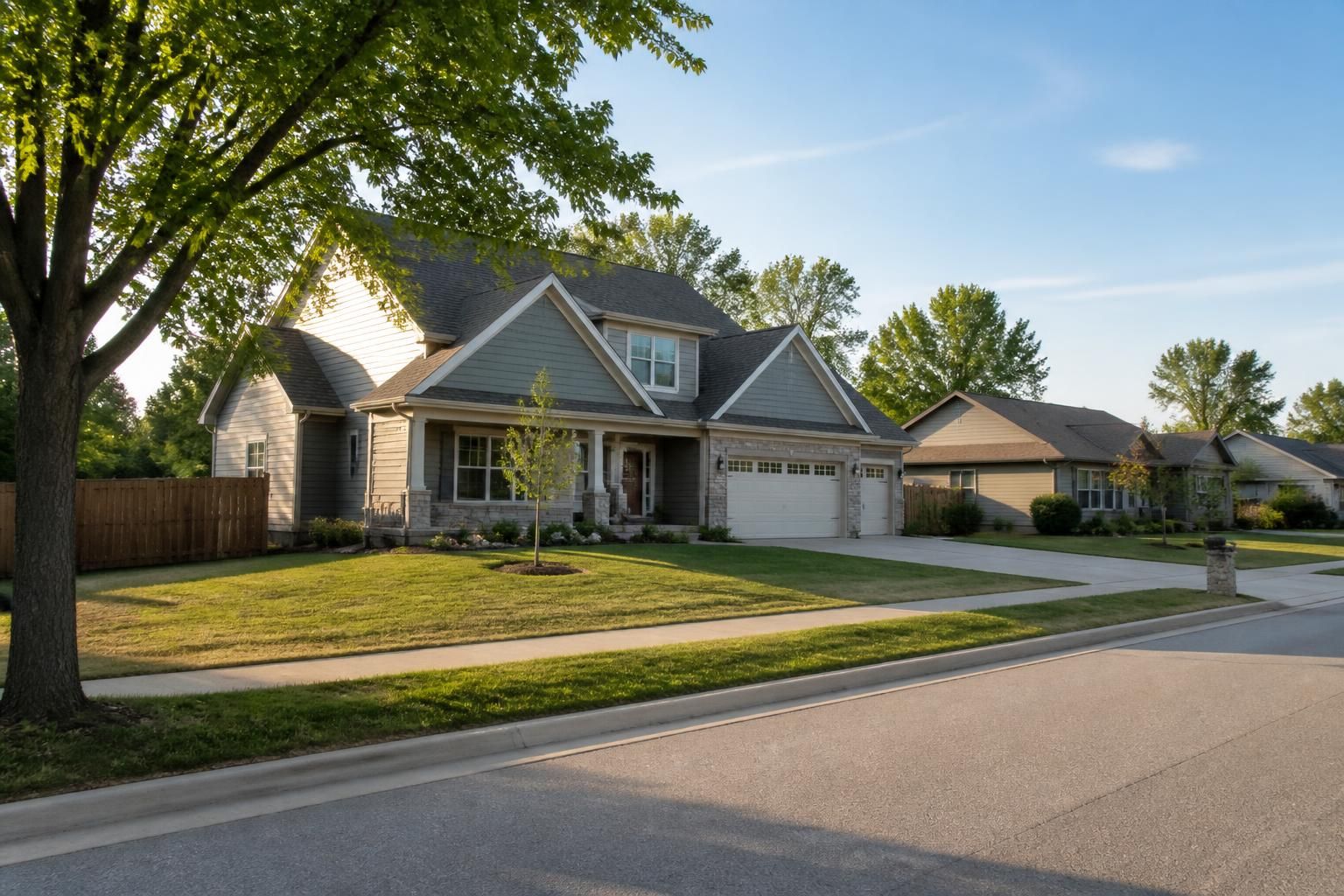Peaceful street with family homes surrounded by greenery.